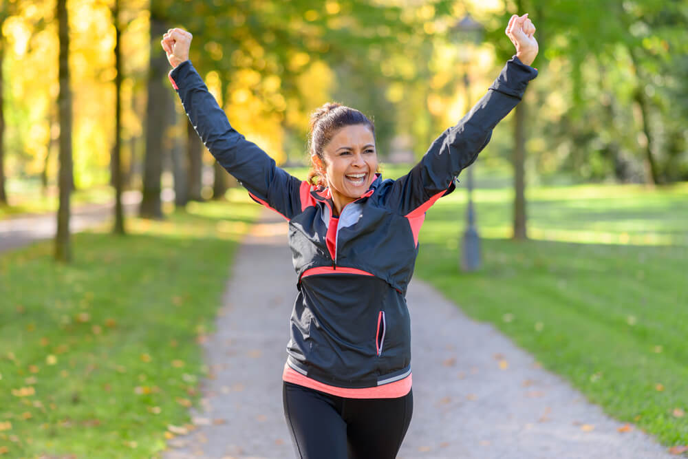 Happy fit middle aged woman cheering and celebrating