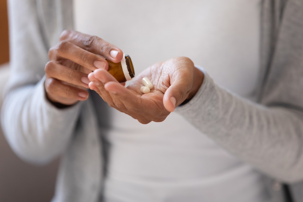 A person opening their Prescription Medications
